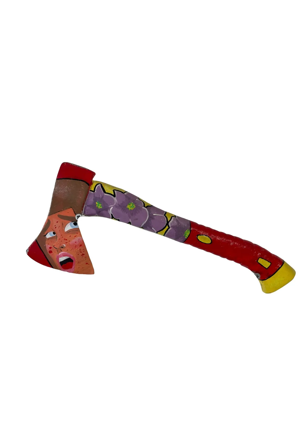 A hatchet painted head to handle: a freckled face with a wide open mouth spans the blade, and purple flowers on a yellow ground run down the shaft into a red grip with a yellow butt.